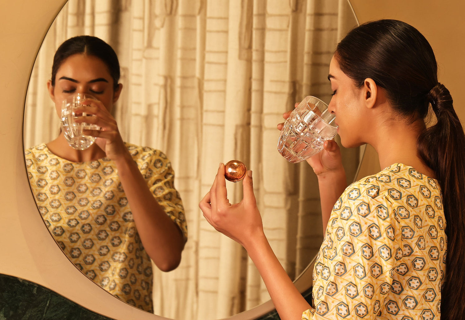 Art of Vedas Ayurveda Copper Energy Ball - Woman Using Copper Energy Ball for Daily Ayurvedic Wellness Ritual